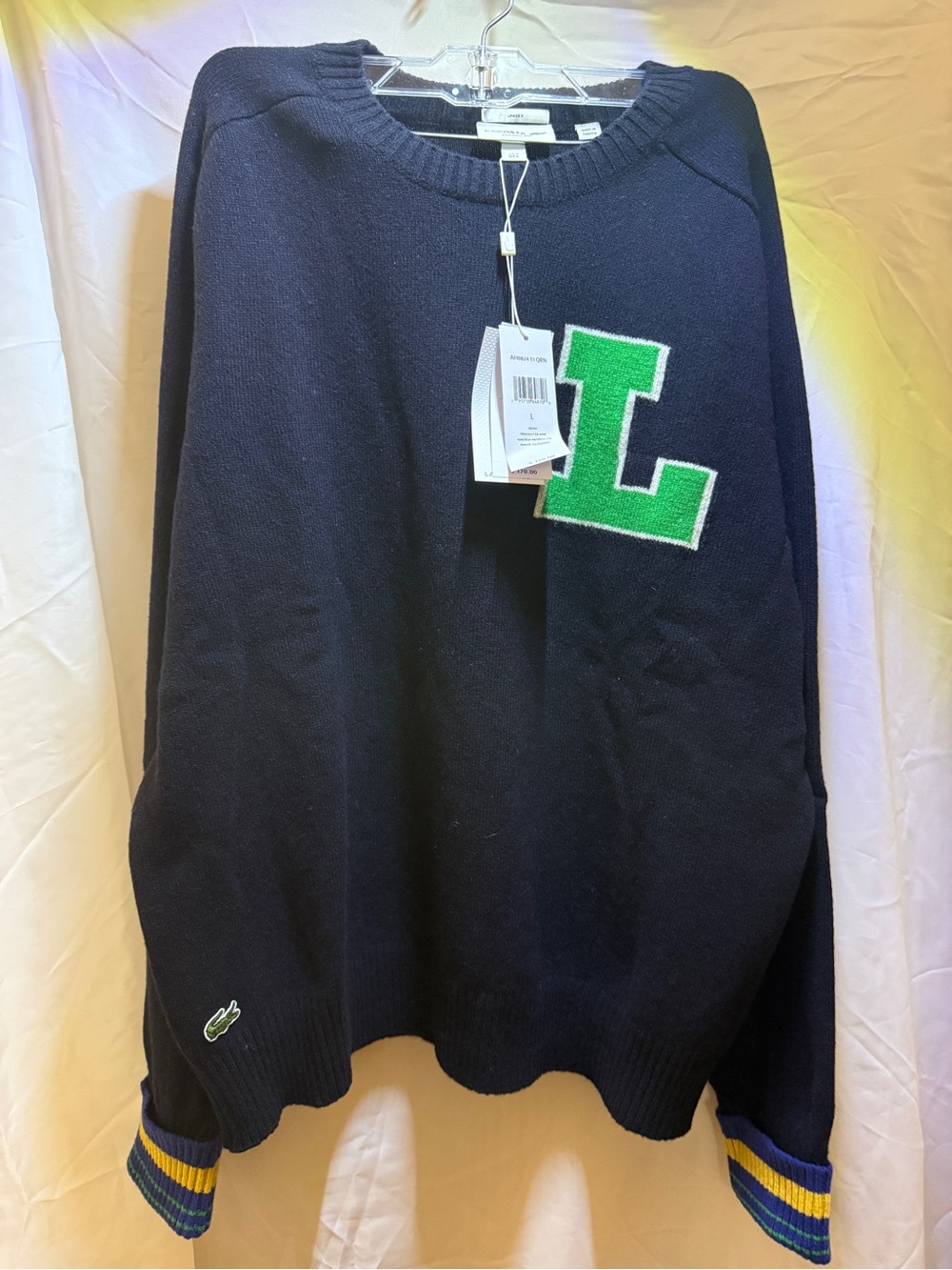 Lacoste Navy Crewneck Sweater with Green 'L' Patch and Yellow-Blue Cuff Stripes